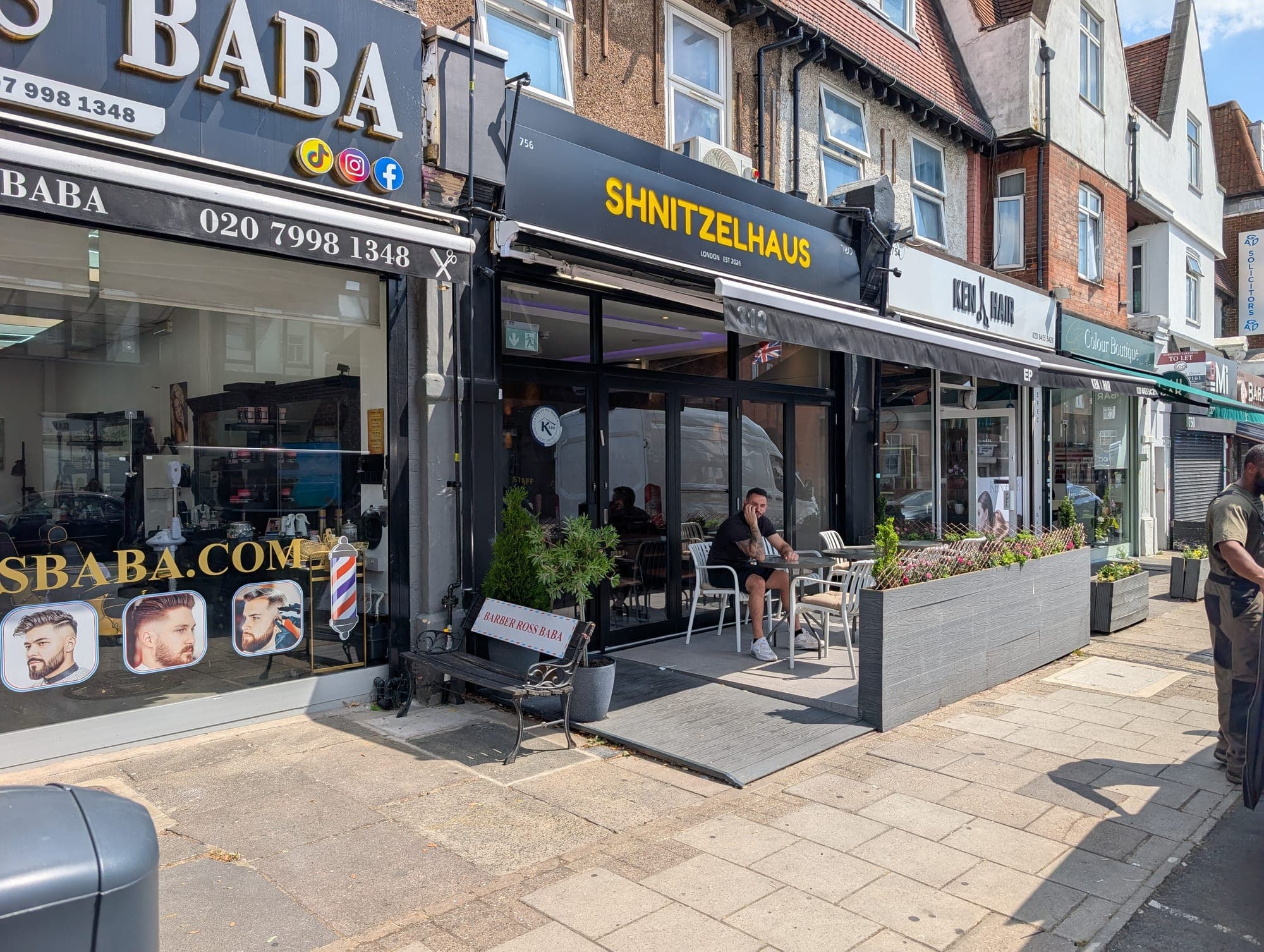 756 Finchley Road: a restaurant unit with black fascia and full-height glazed doors, tables set out on the pavement terrace.